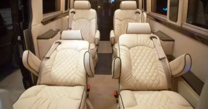 Inside a spacious RV rental, four plush cream quilted captain's chairs invite luxurious travel & relaxation.. Other Other 2020