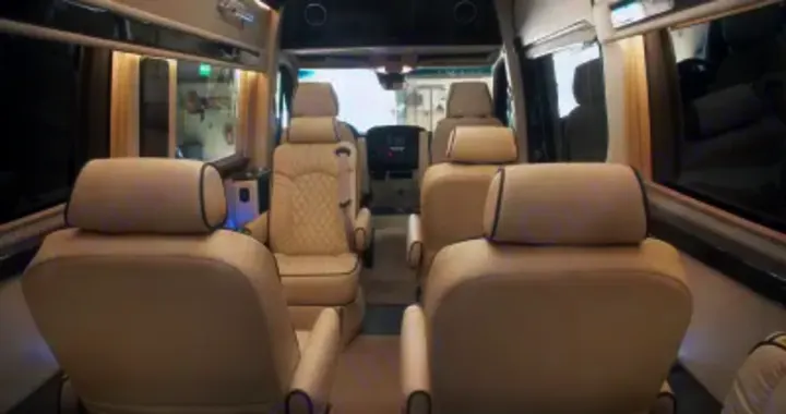 Spacious luxury RV rental interior with cream captain's chairs & ample seating. Perfect for comfortable group travel.. Other Other 2020