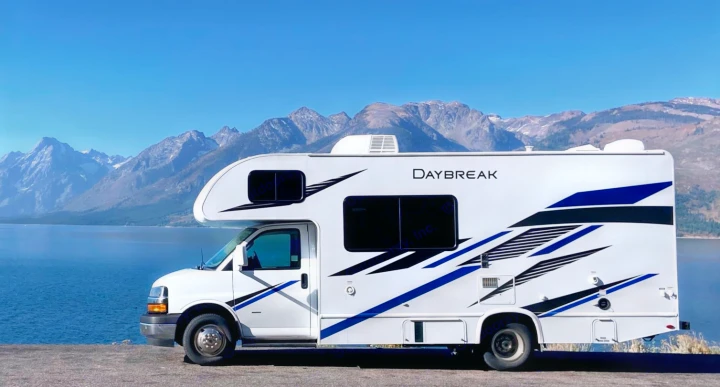 Daybreak RV rental overlooks a serene lake & majestic mountains, perfect for your next scenic adventure.. Thor Daybreak 2021