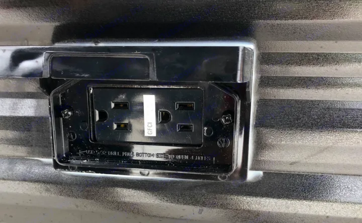 Close-up of an RV rental's exterior GFCI electrical outlet, ready for outdoor power needs.. Keystone RV Hideout 2021