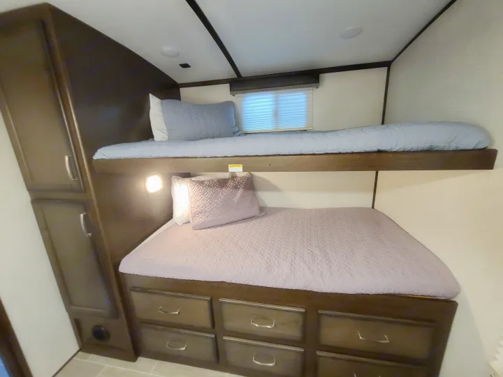 RV rental bunk beds offer comfy sleeping with built-in storage drawers and a cabinet for convenience.. Dutchmen Other 2020