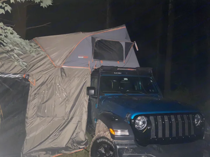 Nighttime camping: Blue Jeep with a Roofnest rooftop tent & attached annex, a versatile RV rental option.. Other Other 2020