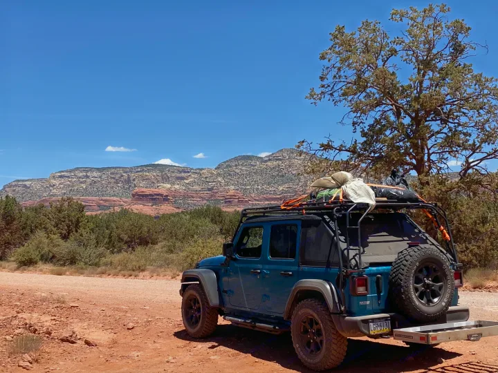 Adventure-ready Jeep on a red dirt road, exploring scenic desert mountains. Like an rv rental experience.. Other Other 2020
