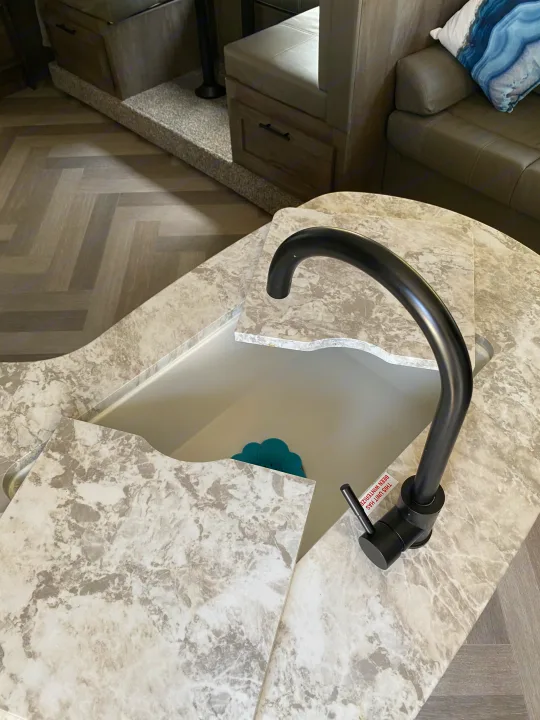 RV rental's modern kitchen features a sleek sink, black faucet, marbled counter. Note: "UNIT HAS NOT BEEN WINTERIZED".. Forest River Salem Cruise Lite 2021