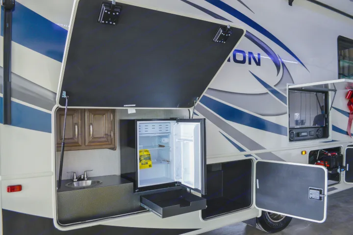 RV rental featuring exterior compartments with an outdoor kitchen (sink, mini-fridge) and entertainment system.. Entegra Coach Other 2021