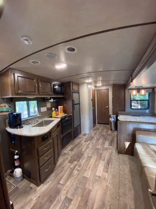 Inside a cozy RV rental: Full kitchen, dining banquette, and lounge area offer home comforts on the road.. Other Other 2018