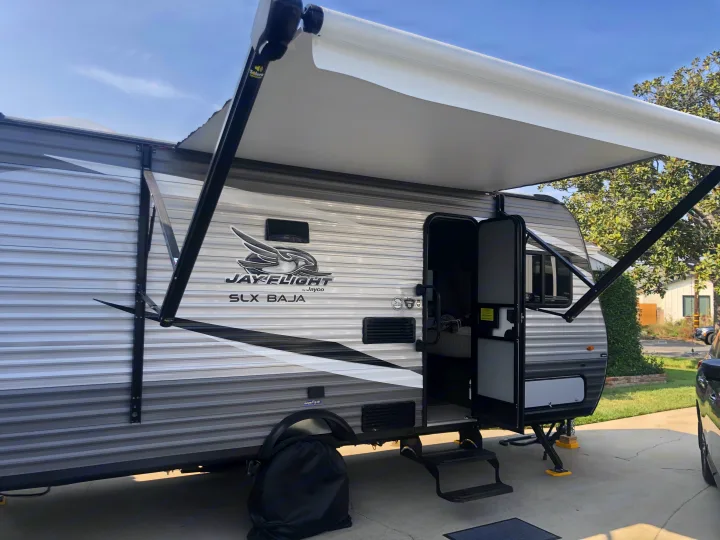 RV rental: A Jayco Jay Flight SLX Baja travel trailer parked with its awning extended & door open for easy entry.. Jayco Jay Flight 2021