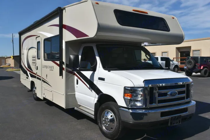 White and beige Class C motorhome RV rental, a Leprechaun model, parked on asphalt for your next adventure.. Coachmen Leprechaun 2020