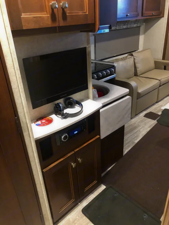 Experience comfort in this RV rental: kitchenette, entertainment system with TV & headphones, and plush seating.. Forest River forester 2019