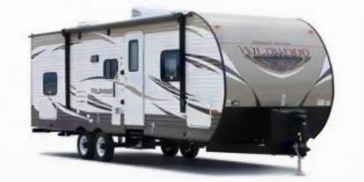 A spacious white and grey travel trailer, perfect for an RV rental adventure. Ideal for family camping and travel.. Forest River Wildwood 2016