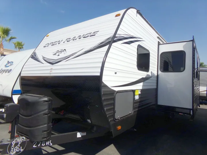 An Open Range travel trailer with an extended slide-out, shown in white and black, is ideal for your next RV rental adventure.. Open Range Open Range 2020