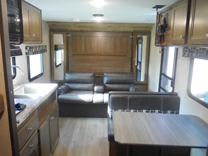 Spacious RV rental interior with kitchen, recliners, and dining booth. Experience comfort on your next adventure!. Coleman Other 2018