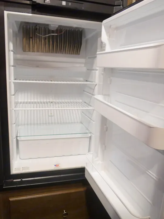 This empty, clean RV rental refrigerator is ready to be stocked for your next adventure, complete with shelves and a crisper.. Coleman Other 2018