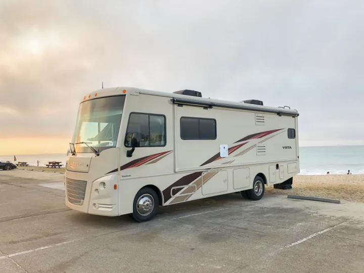 Ideal RV rental spot: a Winnebago Vista motorhome parked beachfront on a paved lot, overlooking the ocean.. Winnebago Vista 2018
