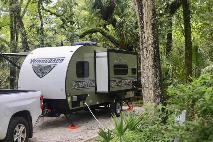 Winnebago Minnie Drop RV rental at a lush, wooded campsite, connected to hookups. Perfect for your next camping adventure!. Other Other 2018