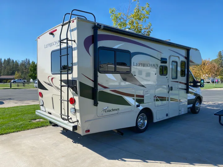 A tan Coachmen Leprechaun rv rental, a Class C motorhome, parked at an RV campground on a sunny day.. Other Other 2020