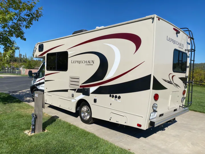 A Coachmen Leprechaun RV rental parked at site 46 in a sunny campground.. Other Other 2020