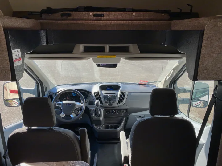 RV rental interior: Ford dashboard and driving cockpit with an overhead bunk above the front seats.. Other Other 2020