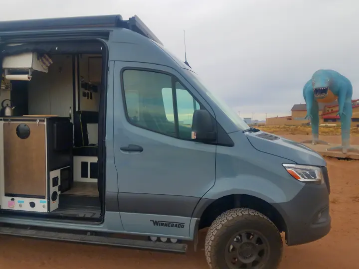 The interior of this Winnebago rv rental is ready for adventure, parked beside a huge blue dinosaur.. Winnebago Revel 2020