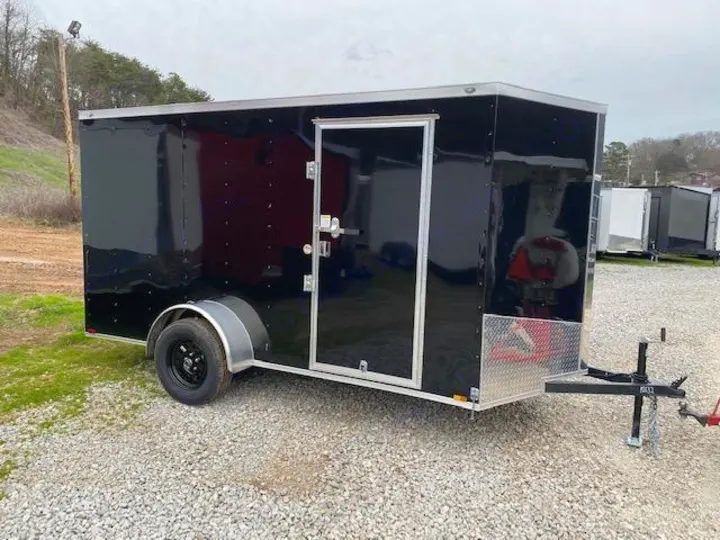 This black enclosed cargo trailer, with its side door and wheel, is ideal for RV rental use or hauling.. LOOK Enclosed  Trailer 2019