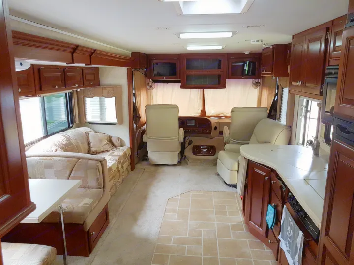 Spacious RV rental interior featuring a lounge, kitchen, and dining area, ideal for comfortable travel.. THOR Four Winds Infinity 2005