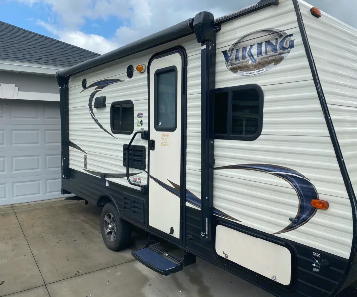 This white and black Viking travel trailer is available for RV rental. Parked in a driveway, ready for your outdoor adventure.. Forest River Other 2018