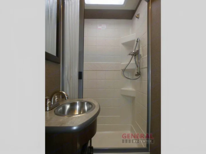 Modern RV rental bathroom with a compact sink, chrome faucet, and bright, tiled shower. See the convenient skylight.. Other A.C.E 2020