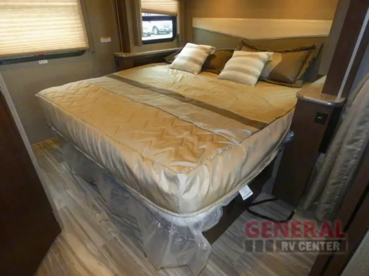 View of a comfortable RV rental bedroom interior, showcasing the bed, headboard, and wood-look flooring.. Other A.C.E 2020