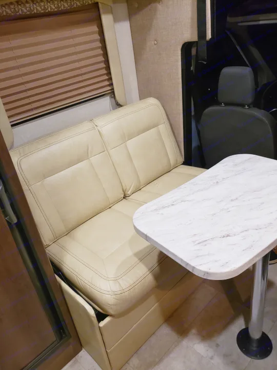 Inside an **rv rental**: a cream dinette with a faux marble table. Perfect for dining or relaxing on your trip.. Coachmen Other 2018