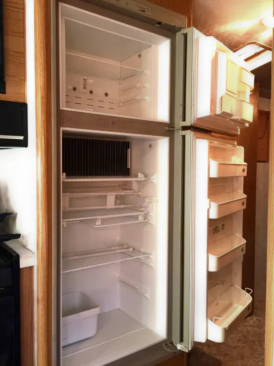Clean, empty refrigerator and freezer in this RV rental, ready for your travel provisions.. Fleetwood Bounder 1999