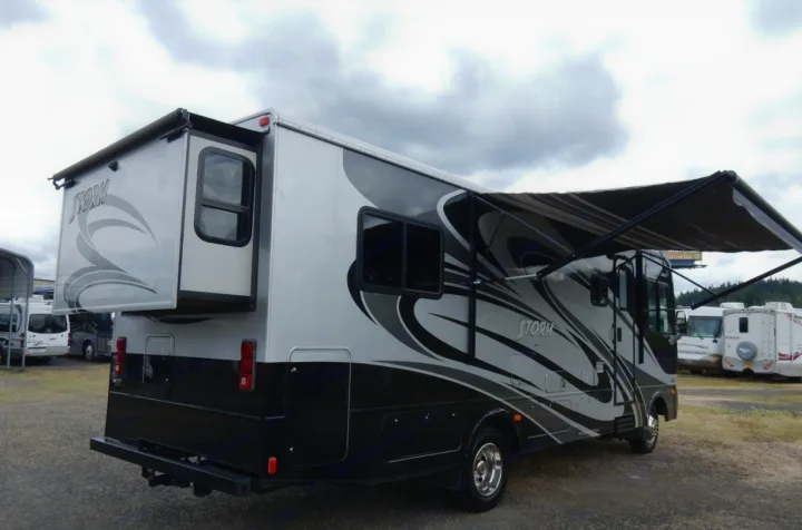 This grey and black motorhome RV rental displays its extended slide-out and awning, ready for your next adventure.. Fleetwood Storm 2013