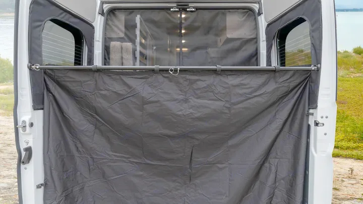 RV rental camper van's rear view, doors open with a grey privacy curtain & mesh screen. Ideal for outdoor shower/changing by the lake.. Winnebago Winnebago 2021