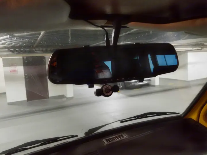 RV rental interior view: digital rearview mirror/dashcam showing parking garage, taken from inside the vehicle.. Volkswagen Westfalia 1982