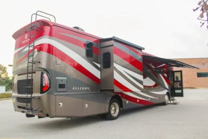 A vibrant red, grey, & white Tiffin Allegro RV with extended slide-outs & awning. Perfect for an upscale RV rental adventure!. Tiffin Motorhomes Allegro Red 2021