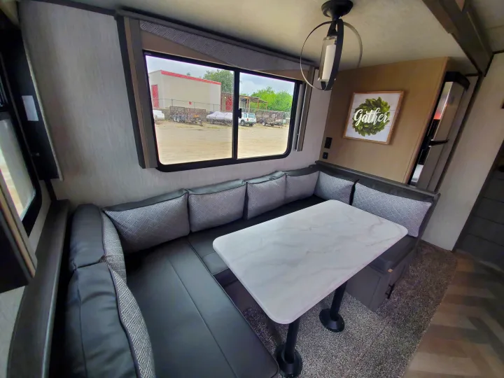Cozy RV rental dinette with U-shaped booth seating and marble-look table, perfect for dining & gathering.. Cruiser Rv Corp Cruiser 2021