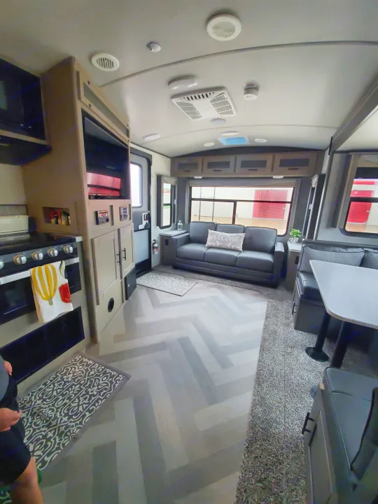 Step inside this modern RV rental! Features a full kitchen, comfy sofa, and dinette with stylish herringbone flooring.. Cruiser Rv Corp Cruiser 2021
