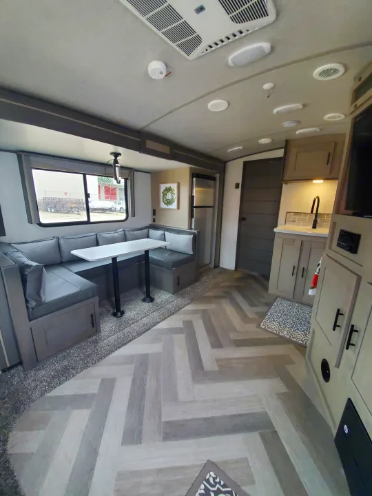 This RV rental showcases a bright, modern interior with a grey dinette, kitchen area, and stylish herringbone flooring.. Cruiser Rv Corp Cruiser 2021