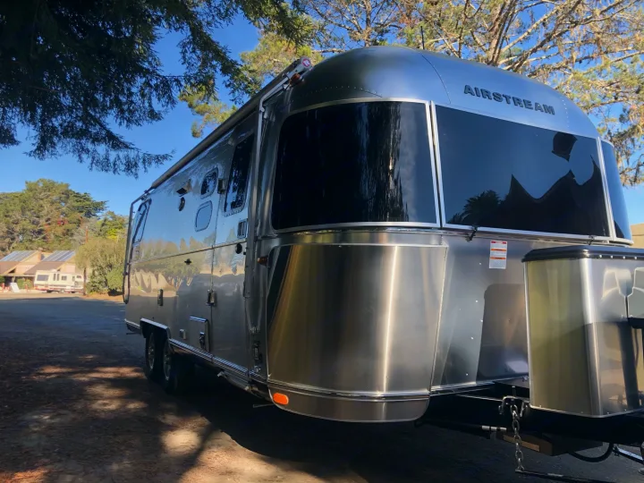 This iconic silver Airstream travel trailer, an ideal RV rental, promises a stylish outdoor adventure.. Airstream Flying Cloud 2019