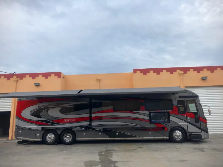 This sleek, grey & red Signature motorhome, with extended awnings & outdoor TV, is perfect for your next rv rental.. Monaco Signature 2020