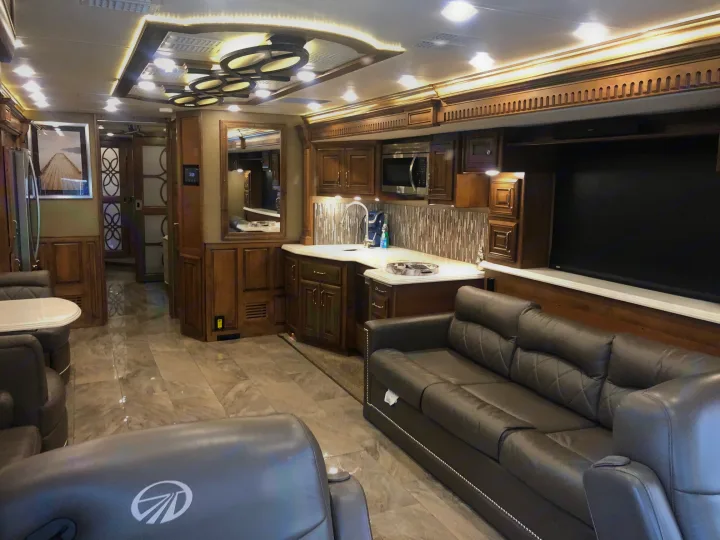 Step into this luxurious RV rental! Features a spacious living area, modern kitchen with wood cabinets, and elegant ceiling design.. Monaco Signature 2020