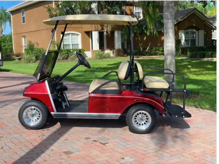 This vibrant red golf cart, parked on a brick driveway, offers fun transport. Inquire about RV rental and other vehicle types!. Keystone Hideout 2016