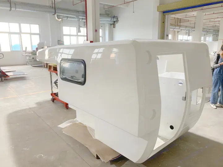 Glossy white RV camper shell in a workshop, ideal for custom builds & future RV rental adventures.. Other Other 2021
