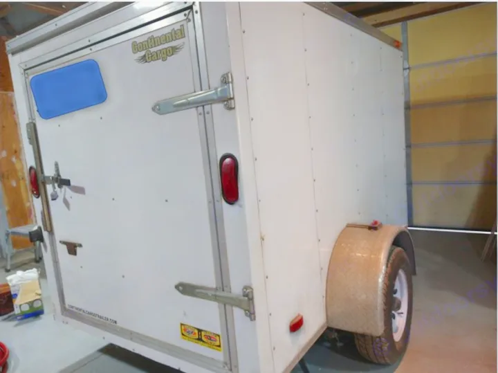 This white Continental Cargo enclosed trailer could serve your RV rental cargo needs. Rear door, wheel visible.. Forest River Continental Cargo 2007