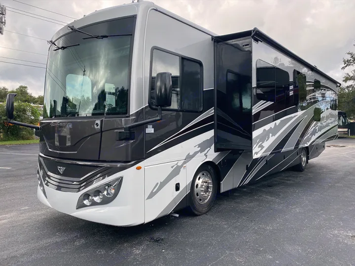 Experience luxury on wheels with this spacious grey and white RV rental motorhome, featuring an extended slide-out for more room.. Fleetwood Pace Arrow 2021