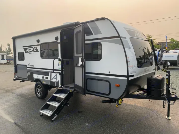 Explore in style! This modern white & gray Apex Nano travel trailer is an ideal rv rental option, with steps extended and a front bike rack.. Coachmen Apex Nano 194 BHS 2021