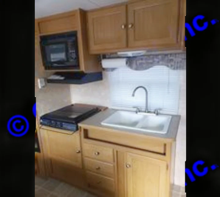 Kitchen sink, stove top, and microwave. Dutchmen Sport 2004