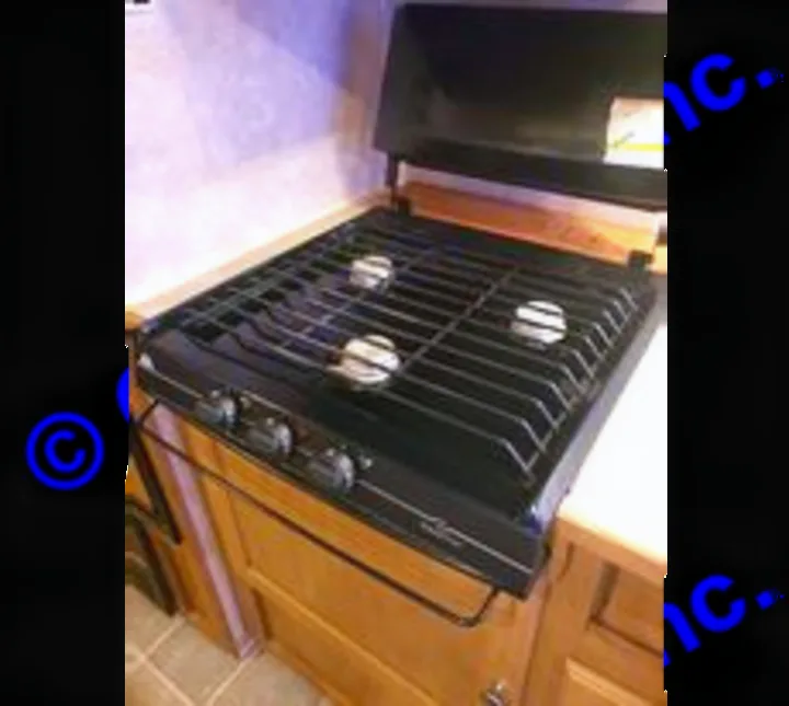 Propane heated stove top with 3 burners. Dutchmen Sport 2004