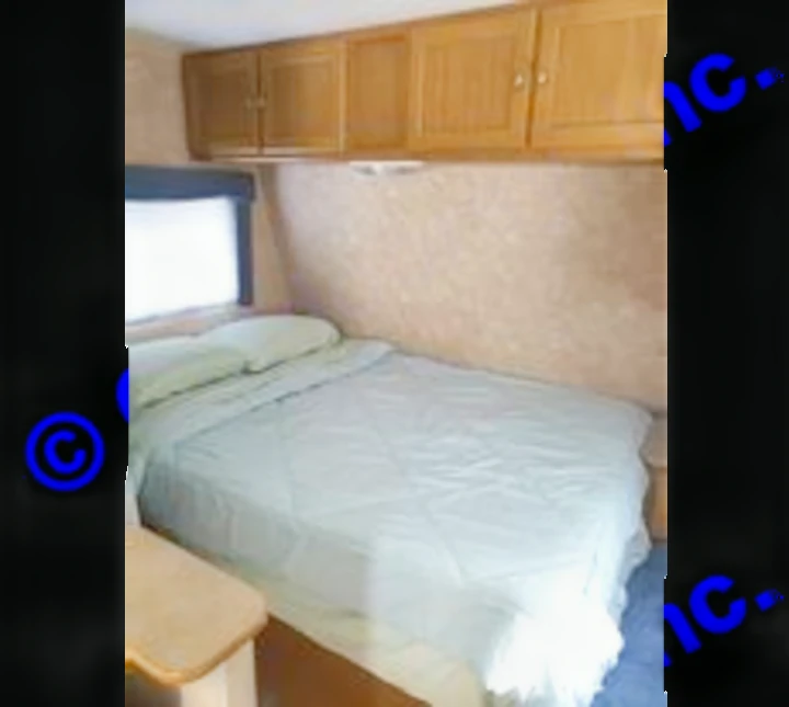 Comfortable full size bedroom for 2 with plenty of storage space. Dutchmen Sport 2004