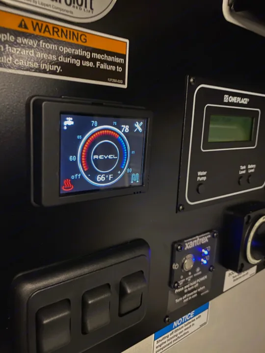 RV rental dashboard: Revel heating (66°F/78°F), OnePlace water pump, and Xantrex inverter controls. Essential RV functions.. Winnebago Revel 2021