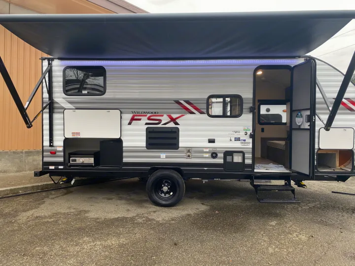 Experience outdoor living! This Wildwood FSX RV rental features an extended awning, LED lights, and an outdoor kitchen.. Forest River Wildwood Sport 2021